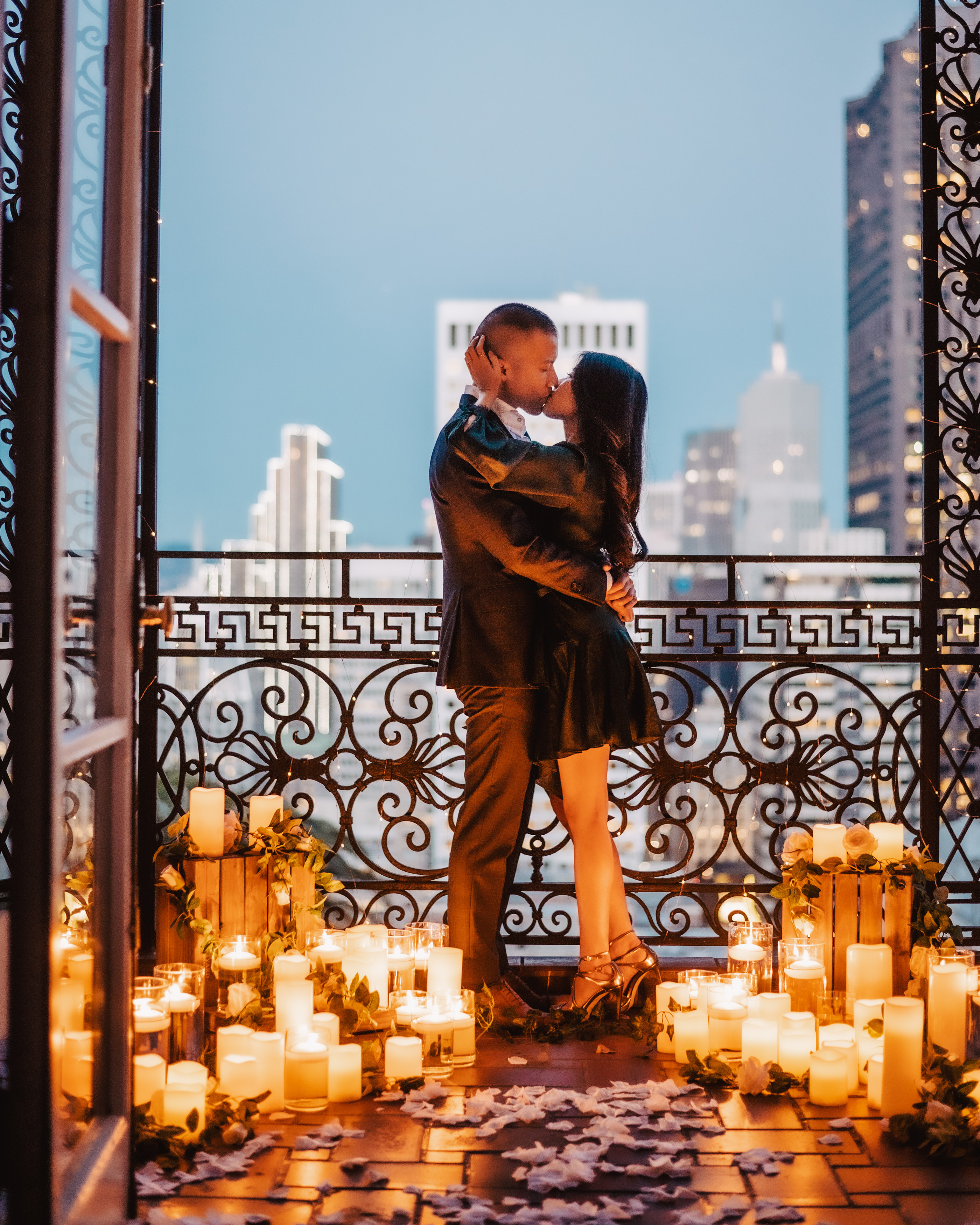 Candlelit proposal on a balcony at the Fairmont in San Francisco during blue hour