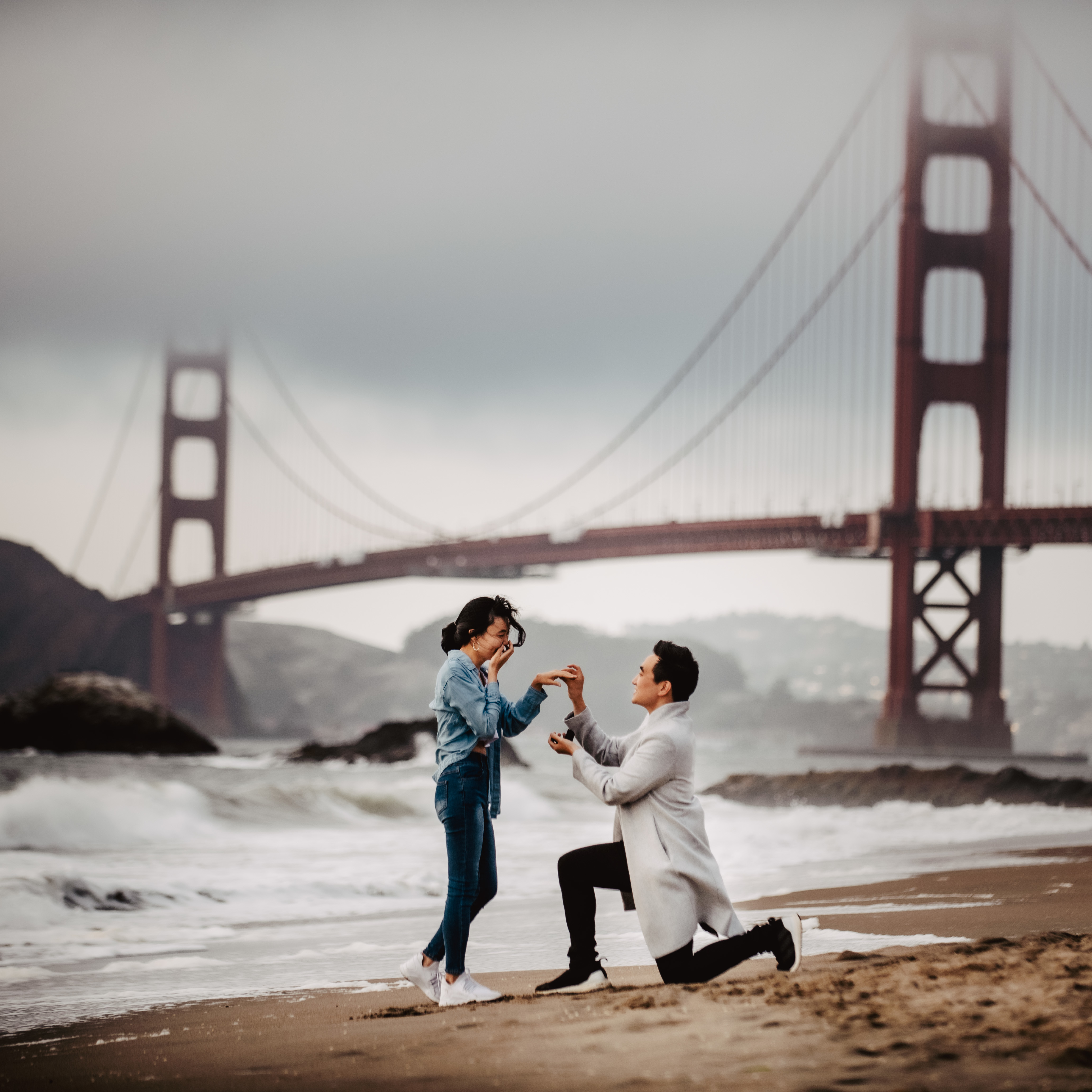 Actual proposal at Baker Beach on a cloudy day with the Golden Gate Bridge in the background